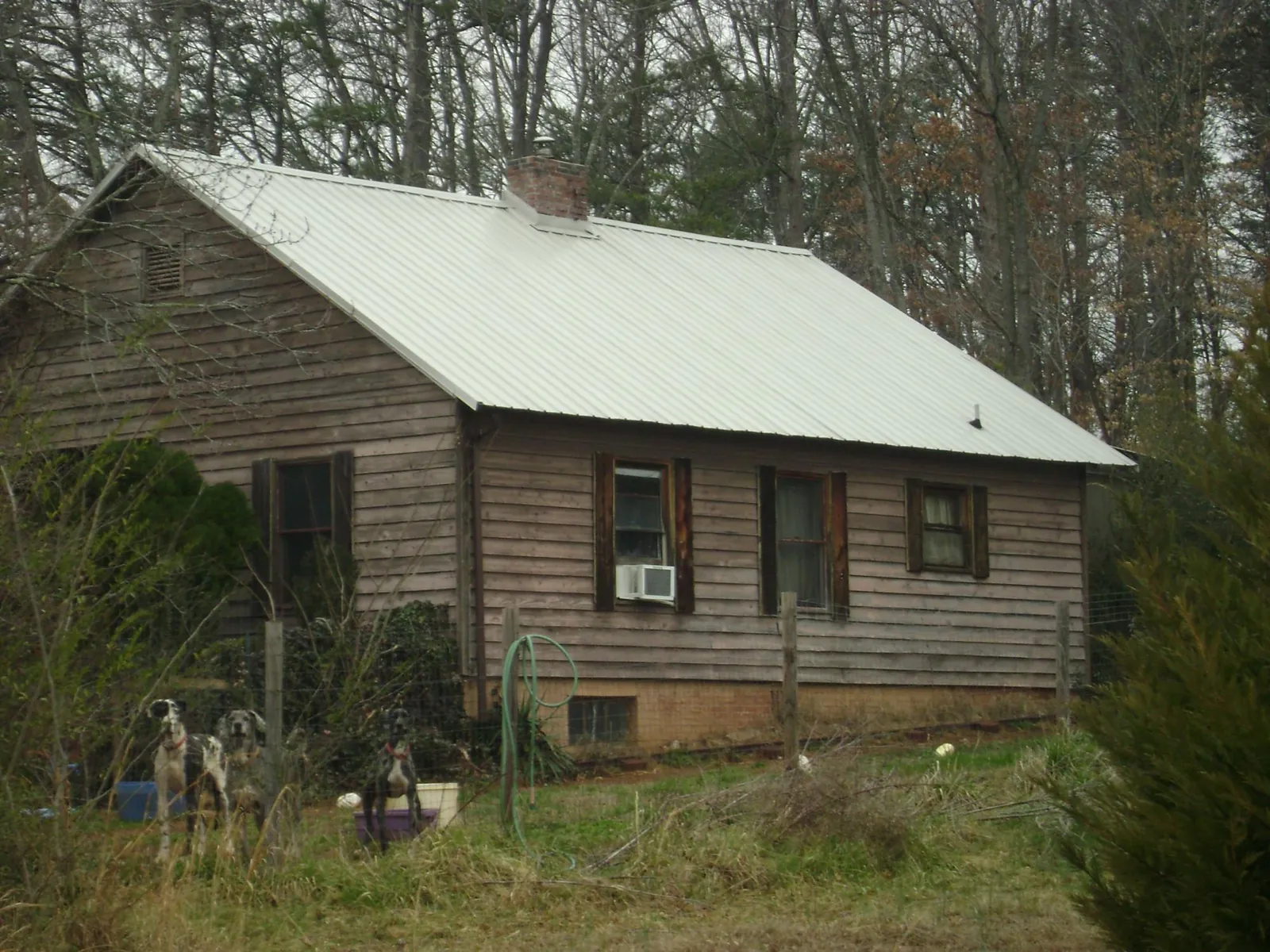 White metal roof on an old wood sided farmhouse, from a Asphalt Shingle Roof Repair job in Darlington